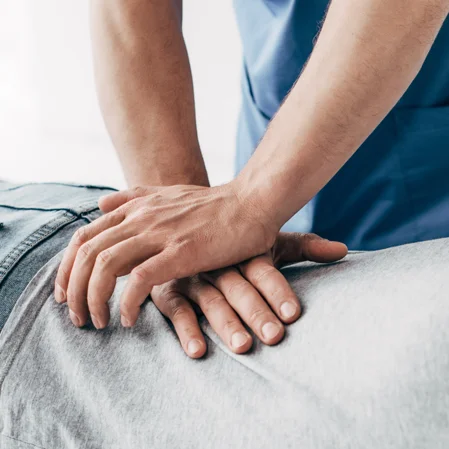 A chiropractor adjusting a patient's lower back